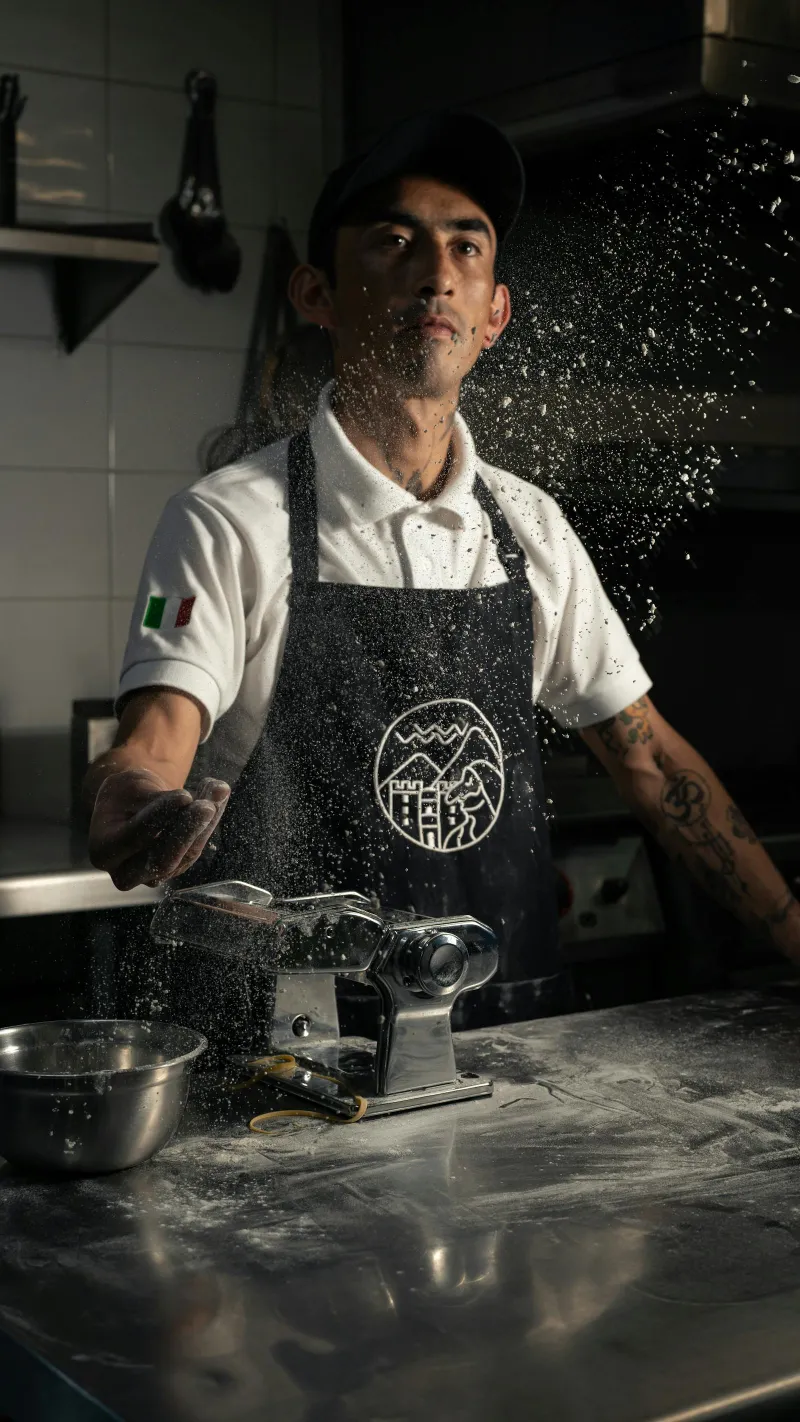 Mila's chef hand-tossing fresh pasta dough in the kitchen